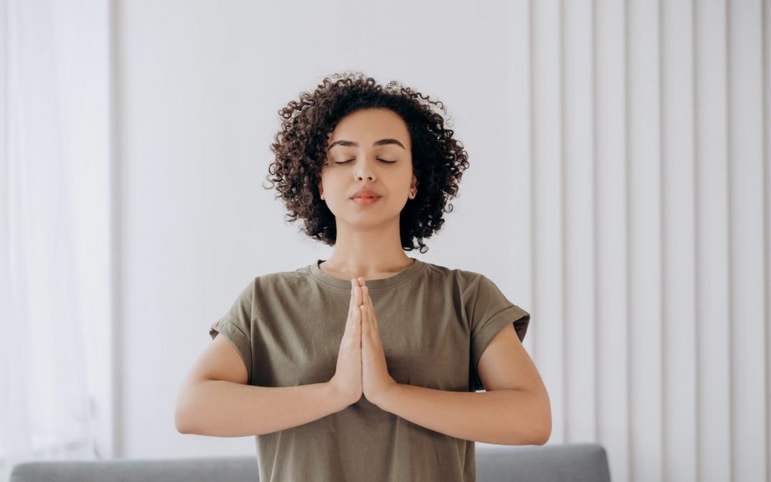 woman in gray crew neck t shirt in a yoga position